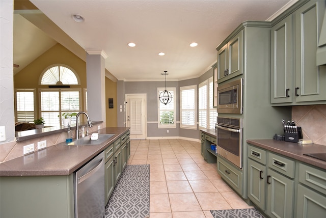 kitchen featuring appliances with stainless steel finishes, plenty of natural light, sink, and green cabinets