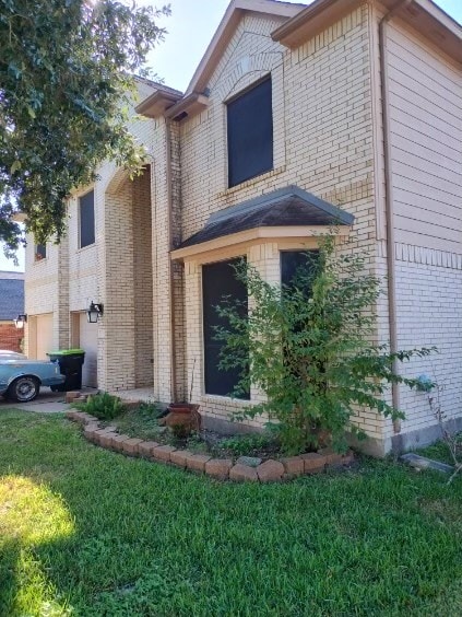 view of side of home with a lawn