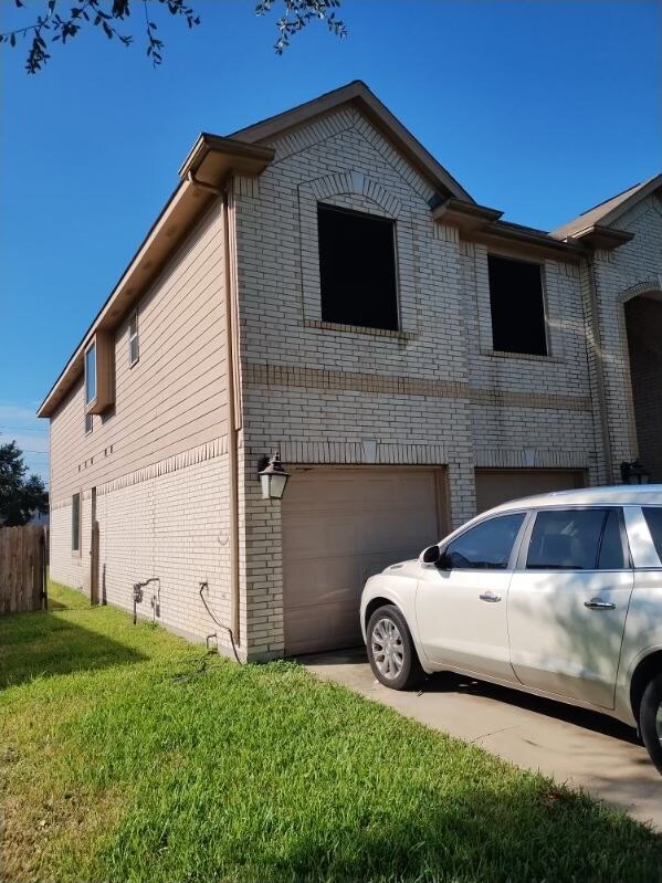 view of home's exterior with a yard and a garage