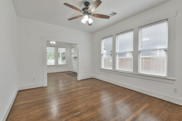 spare room with ceiling fan and dark wood-type flooring