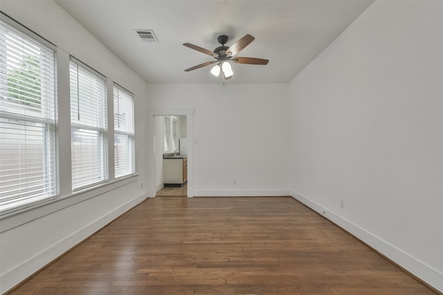 empty room featuring ceiling fan and hardwood / wood-style flooring