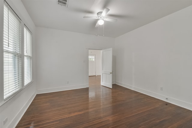 unfurnished room featuring ceiling fan and dark hardwood / wood-style flooring