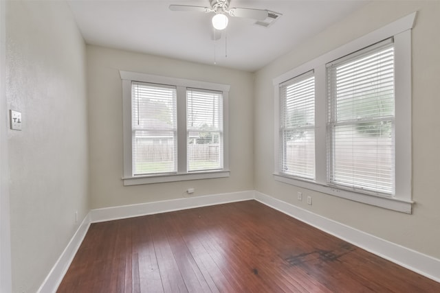 spare room featuring ceiling fan and dark hardwood / wood-style flooring