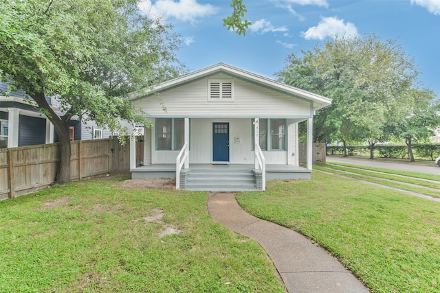 bungalow with a front lawn and a porch