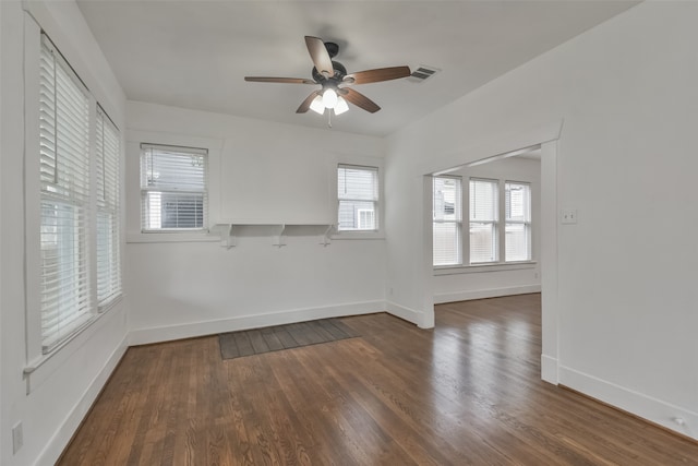 spare room featuring ceiling fan and dark hardwood / wood-style floors