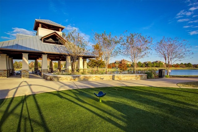 view of home's community featuring a water view, a gazebo, and a yard