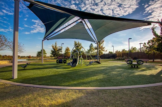 view of community featuring a playground and a lawn