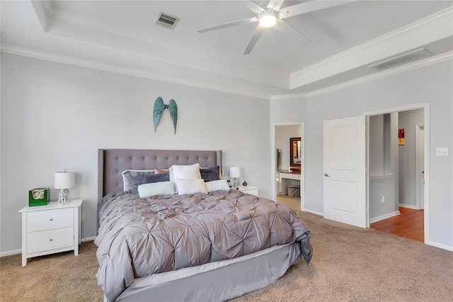 bedroom with crown molding, ensuite bath, ceiling fan, and light carpet