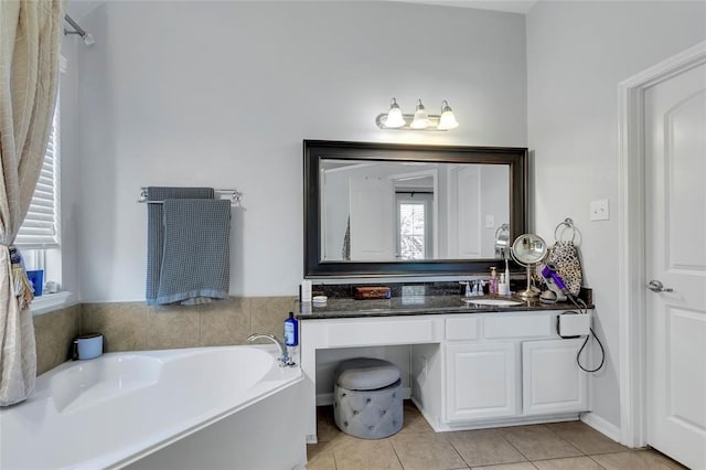 bathroom with vanity, a tub to relax in, and tile patterned flooring