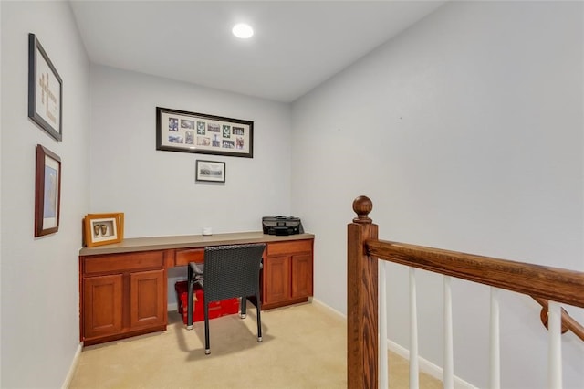 carpeted home office with built in desk