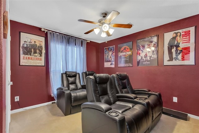 carpeted cinema room featuring ceiling fan