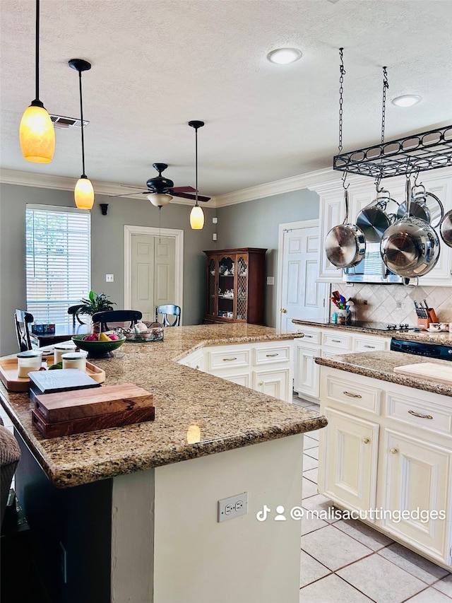 kitchen featuring a kitchen island, ceiling fan, light tile patterned flooring, pendant lighting, and ornamental molding