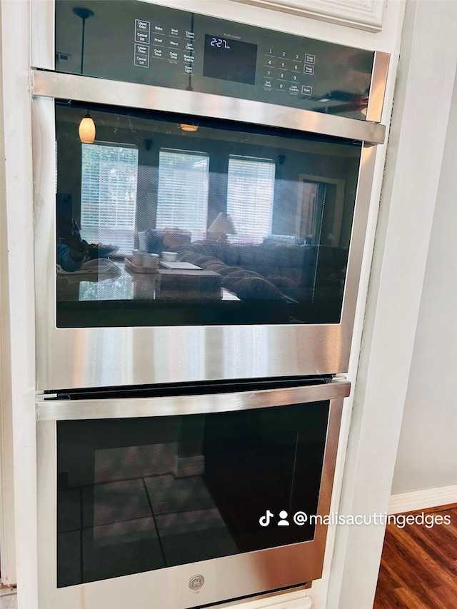 details featuring double oven and hardwood / wood-style flooring