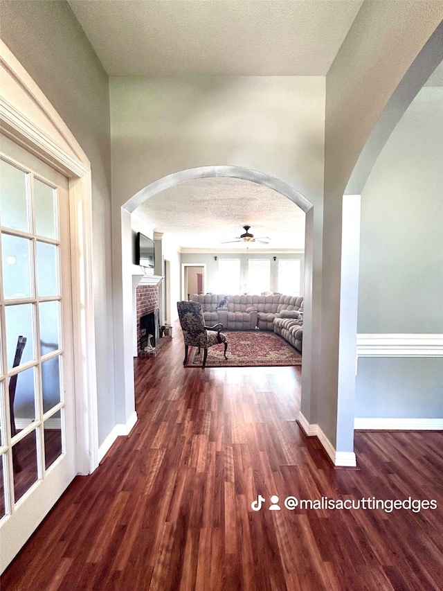 hall featuring dark hardwood / wood-style flooring and a textured ceiling