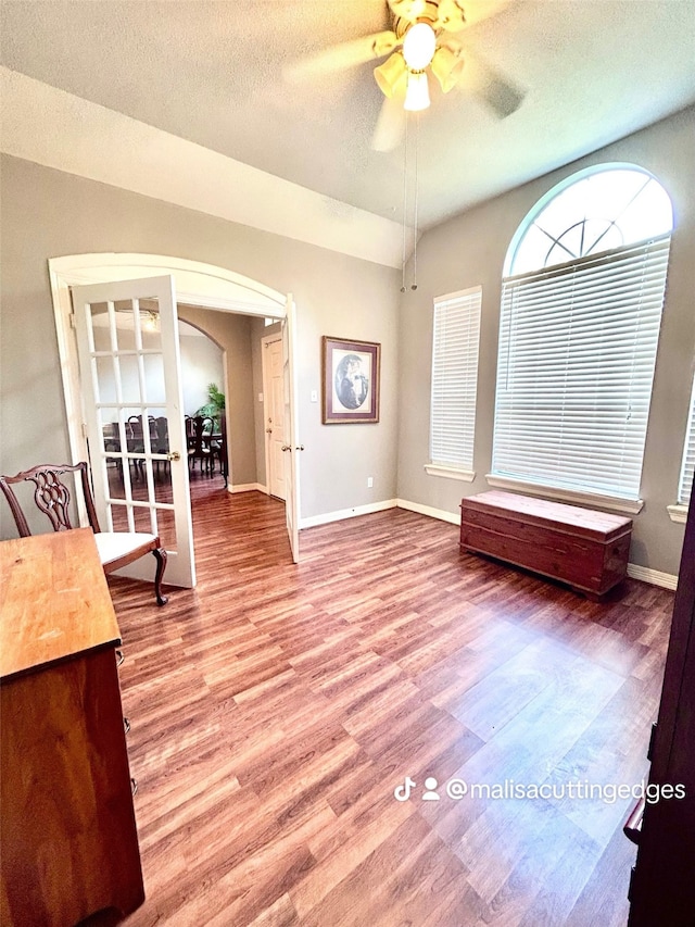 unfurnished room with ceiling fan, a textured ceiling, and hardwood / wood-style floors