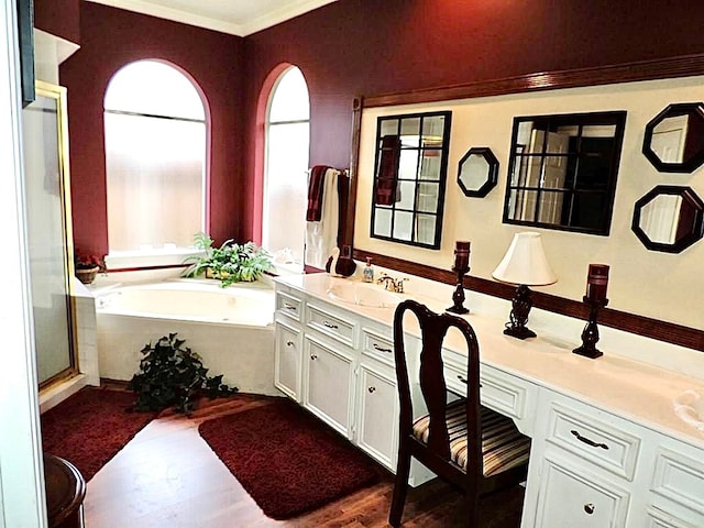 bathroom featuring vanity, shower with separate bathtub, ornamental molding, and wood-type flooring