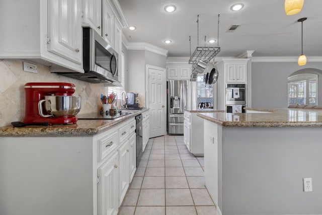 18106 Briden Oak Ct, Spring, TX 77379 - kitchen featuring black appliances, crown molding, a center island, white cabinetry, and arched walkways