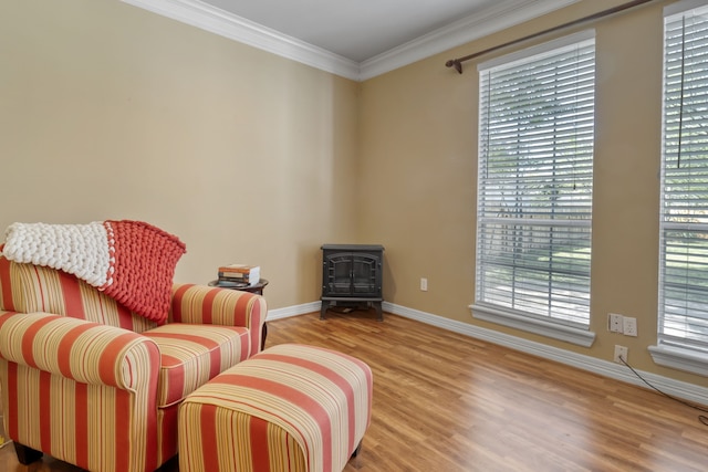 18106 Briden Oak Ct, Spring, TX 77379 - sitting room with a wood stove, wood finished floors, baseboards, and crown molding