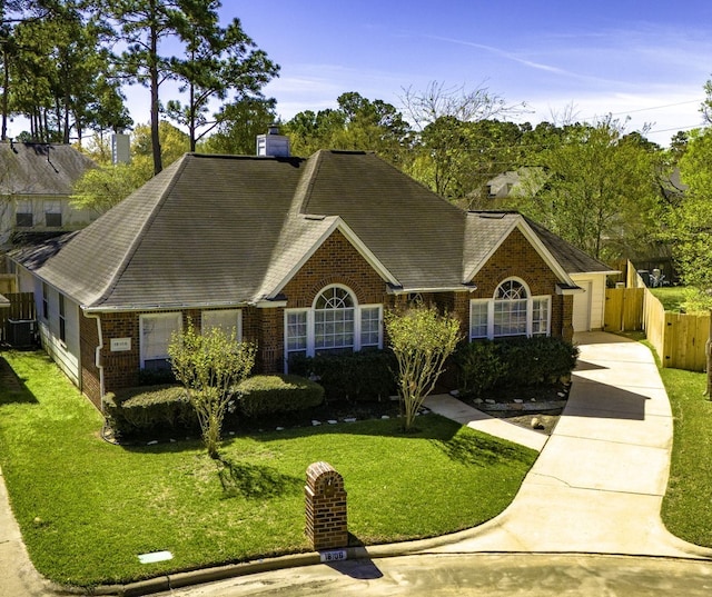 18106 Briden Oak Ct, Spring, TX 77379 - view of front of property with brick siding, roof with shingles, central AC, a garage, and driveway