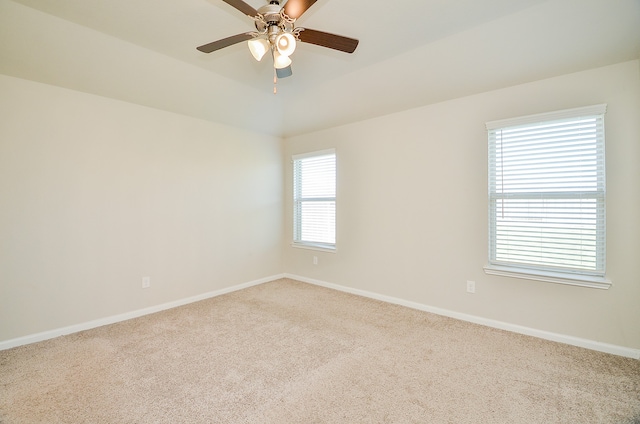 carpeted empty room featuring ceiling fan