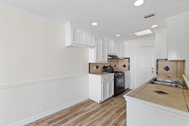 kitchen featuring white cabinetry, black range with gas cooktop, and sink