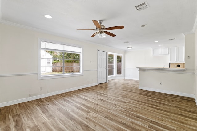 unfurnished living room featuring ceiling fan, light hardwood / wood-style flooring, and ornamental molding