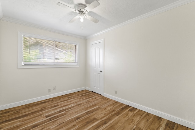 spare room featuring wood-type flooring, a textured ceiling, crown molding, and ceiling fan