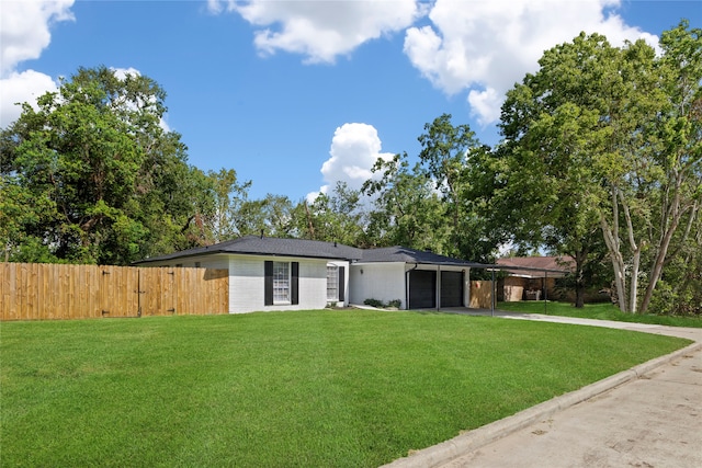 single story home with a front yard and a garage