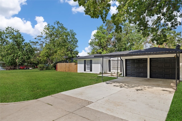 ranch-style home featuring a front lawn and a garage