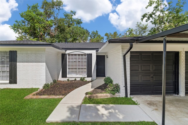 ranch-style home with a front yard and a garage