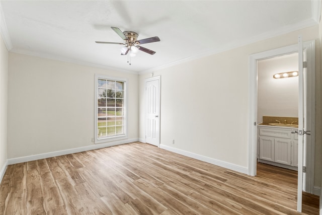 spare room featuring ceiling fan, light wood-type flooring, crown molding, and sink