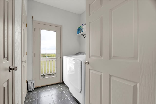 washroom with independent washer and dryer and dark tile patterned floors