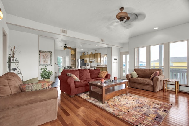 living room featuring light wood-type flooring and ceiling fan