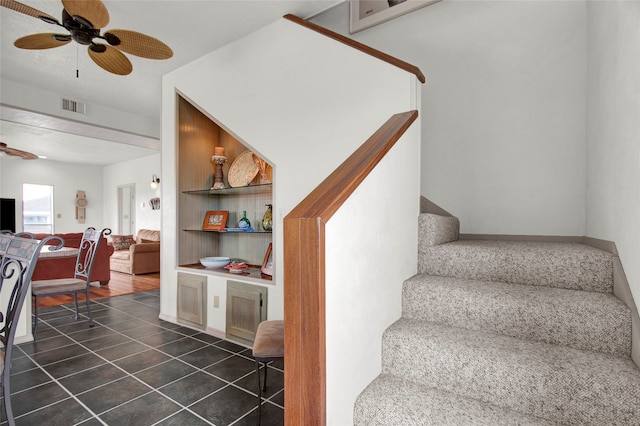 stairs with tile patterned flooring and ceiling fan