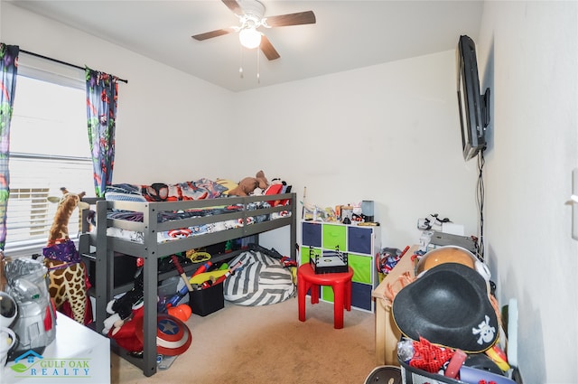 carpeted bedroom featuring ceiling fan and multiple windows