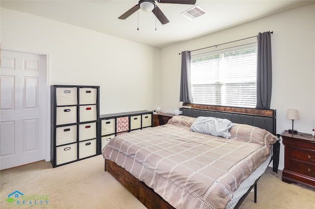 bedroom with light carpet and ceiling fan