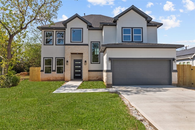 view of front of home with a garage and a front yard