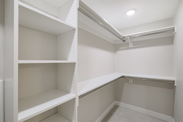 spacious closet with light tile patterned floors