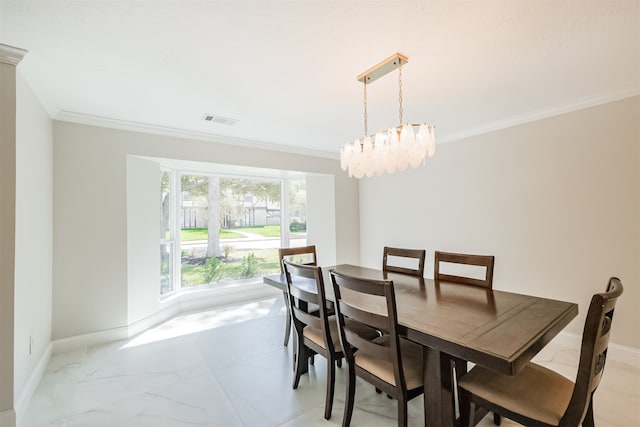 dining room featuring crown molding and a notable chandelier