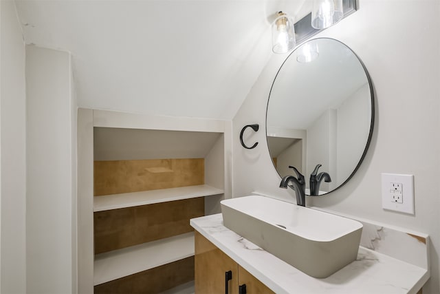 bathroom with vanity and vaulted ceiling