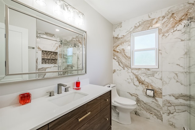 bathroom with toilet, an enclosed shower, and vanity