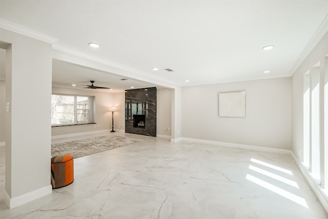 unfurnished living room featuring a fireplace, ornamental molding, and ceiling fan