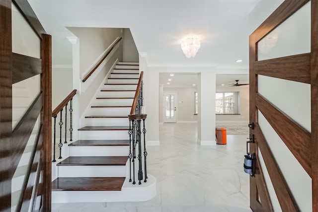 foyer featuring a notable chandelier and crown molding