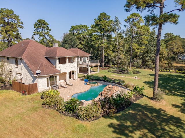 view of pool featuring an in ground hot tub, a patio, and a lawn