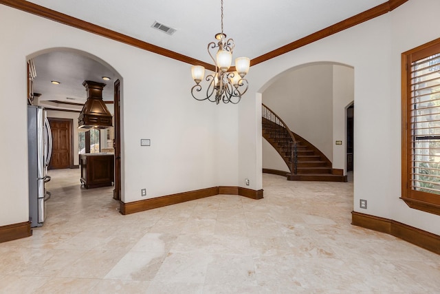 unfurnished room featuring ornamental molding and a notable chandelier