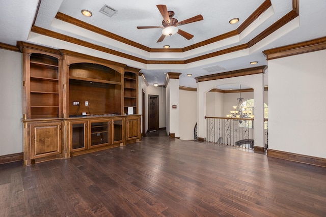 unfurnished living room with crown molding, dark wood-type flooring, a raised ceiling, and ceiling fan with notable chandelier