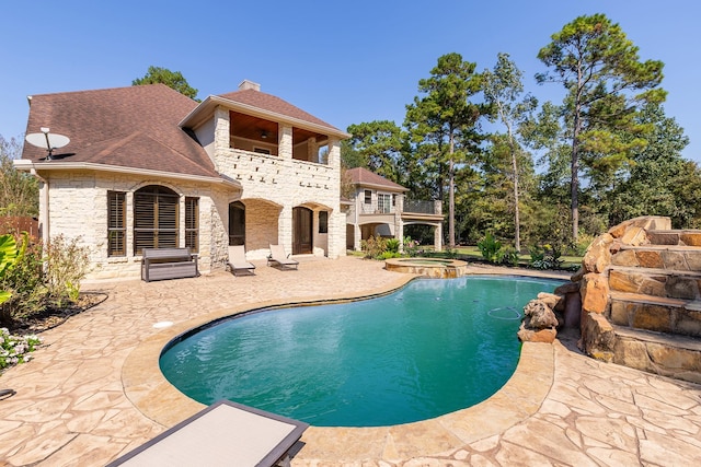 view of swimming pool featuring an in ground hot tub and a patio area