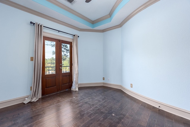 foyer entrance with french doors, ornamental molding, a tray ceiling, and dark hardwood / wood-style flooring