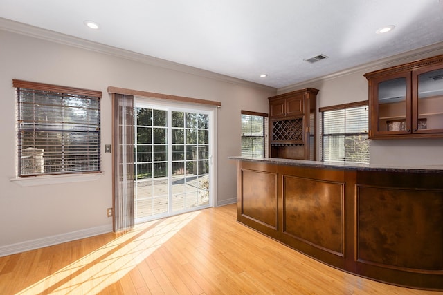 interior space featuring crown molding and light wood-type flooring