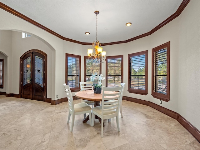 dining space with a notable chandelier and crown molding